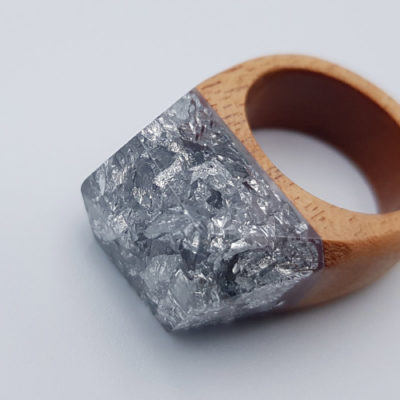 Resin ring filled with  silver leaf and wooden base size 54
