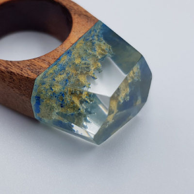 Resin ring in light blue and yellow  with wooden base