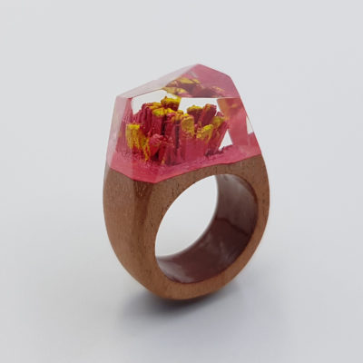 Resin ring in red and yellow color with wooden base