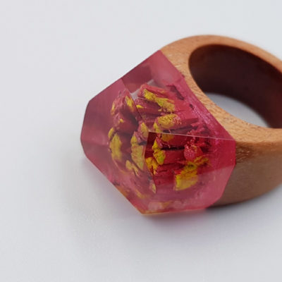 Resin ring in red and yellow  with wooden base