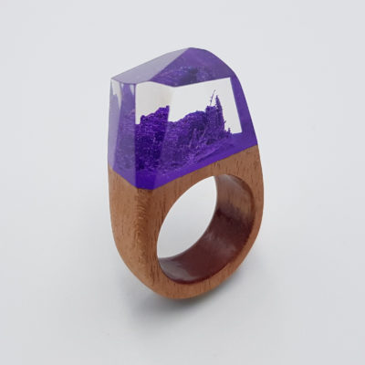 Resin ring in purple color with wooden base