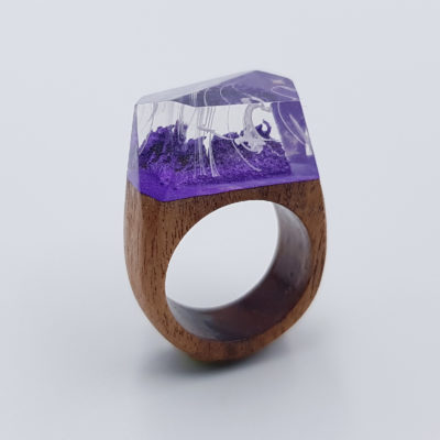 Resin ring in purple color and white waves with wooden base