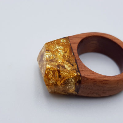 Resin ring filled with  gold leaf and wooden base size 57