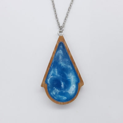 Resin necklace small, triangle to round design in light blue color with wooden bezel
